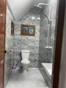 a bathroom with a toilet and a sink and a shower at JozaniBiospherevillage in Jozani