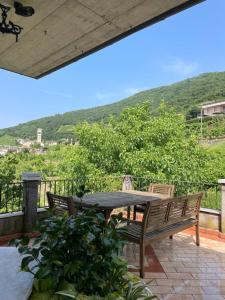 a patio with a table and two chairs and a mountain at Silvia Miotto's Guesthouse in Guia