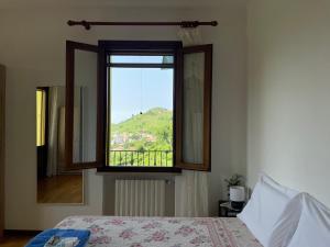 a bedroom with a window with a view of a mountain at Silvia Miotto's Guesthouse in Guia