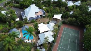 an aerial view of a house with a tennis court at Kellys Beach Resort in Bargara