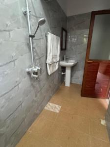 a bathroom with a sink and a toilet and a shower at JozaniBiospherevillage in Jozani