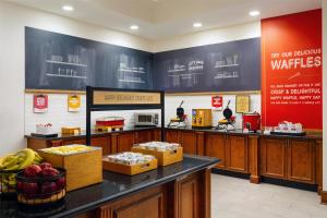 a waiting room with a counter with boxes of food at Hampton Inn & Suites Knoxville-Turkey Creek Farragut in Knoxville