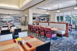 a restaurant with tables and chairs and a bar at Hilton Garden Inn Blacksburg University in Blacksburg