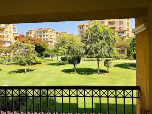 a view of a park with trees and buildings at Luxury Inn 3BR Amazing Garden view in Madinaty B1 in Madinaty