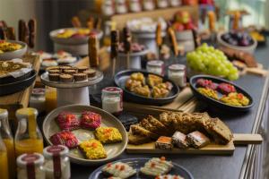 a table filled with different types of food on plates at Hilton Frankfurt Airport in Frankfurt/Main