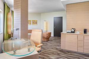 a hotel room with a glass table in a room at Hilton Frankfurt Airport in Frankfurt/Main