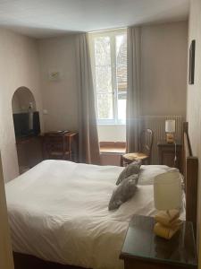 Postel nebo postele na pokoji v ubytování Hôtel des Cymaises