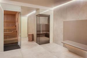 a bathroom with a walk in shower and a walk in closet at Hilton Frankfurt Airport in Frankfurt/Main