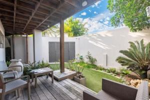 an outdoor patio with a table and chairs at 29 Cutty Sark in Plettenberg Bay