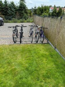 a group of bikes parked next to a fence at Urocze domki #1, Domek Sitno 69F KASZUBY in Sitno