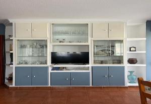 a large entertainment center with blue and white cabinets at Mogro Las Dunas - Relax Total en Apartamento con Jardín in Miengo