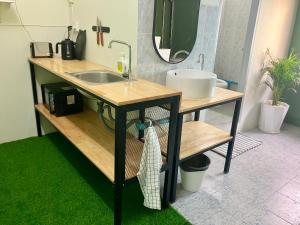 a bathroom with a sink and a mirror at 326 Podtel at The Breakie Bar in Bangkok