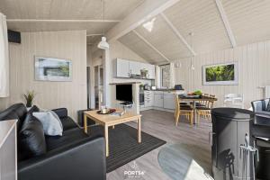 a living room with a couch and a table at Ferienhaus Harter Brocken - Sankt Andreasberg im Harz in Sankt Andreasberg