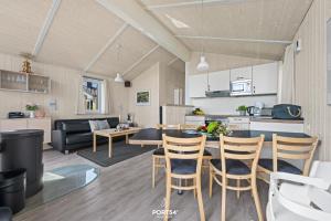 a kitchen and a living room with a table and chairs at Ferienhaus Harter Brocken - Sankt Andreasberg im Harz in Sankt Andreasberg