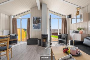 a living room with a table and a fireplace at Ferienhaus Harter Brocken - Sankt Andreasberg im Harz in Sankt Andreasberg +32 photos