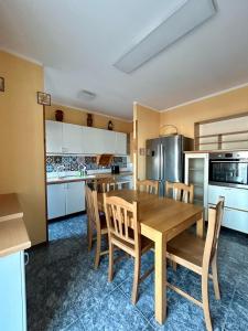 a kitchen and dining room with a wooden table and chairs at Molise Rigenera in Isernia