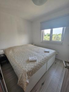 a bedroom with a bed with two towels on it at Apartman Franka in Labin