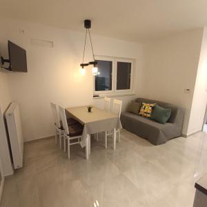a living room with a table and a couch at Apartman Franka in Labin