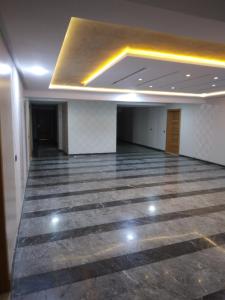 a large empty room with ailed floor and a ceiling at Bab fes Appartement 2 pièces à Aïn Sebaâ Casablanca in Aïn Sebaa +1 photo