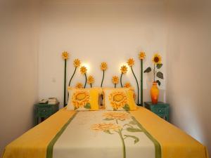 a bedroom with a bed with flowers on it at Betica Hotel Rural in Pias