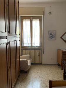 a living room with a window and a couch at Tra Fiori e Antichità in Cerchiara +84 photos