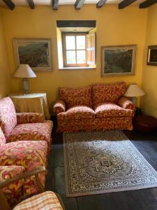 a living room with a couch and a window at La Casita in Cabezón de Liébana