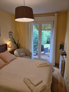 a bedroom with a bed and a sliding glass door at Apartamento turístico Aguere in Ribadesella