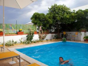 a woman is swimming in a swimming pool at Betica Hotel Rural in Pias