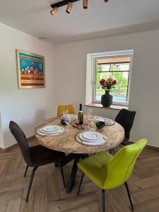 a dining room with a wooden table and chairs at Chez Eugénie et Alphonse in Niedermorschwihr