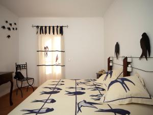 a bedroom with a bed with a bedspread with fish on it at Betica Hotel Rural in Pias