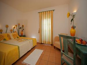 a bedroom with a bed and a couch and a table at Betica Hotel Rural in Pias +37 photos