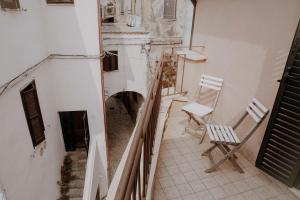 an empty hallway with two chairs in a building at B&B Vicolo Vecchio in Terracina +20 photos