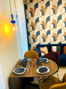 a table with chairs and plates on top of it at Appartement hyper centre Balcon in Périgueux