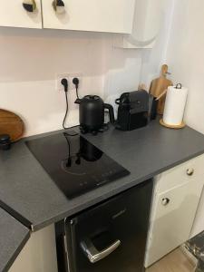 a kitchen counter with a black stove top oven at Appartement hyper centre Balcon in Périgueux +1 photo