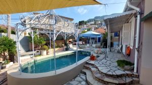 a swimming pool in the middle of a house at Niriides Apartments & Studio in Vathi