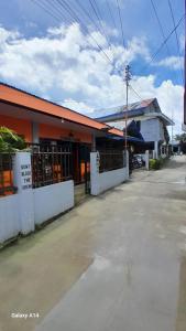 an empty parking lot in front of a building at Panagsama Tourist Inn in Moalboal +13 photos