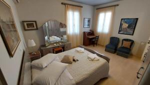 a bedroom with a bed and a table and chairs at Niriides Apartments & Studio in Vathi +54 photos