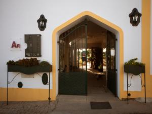 an entrance to a building with a green door at Betica Hotel Rural in Pias