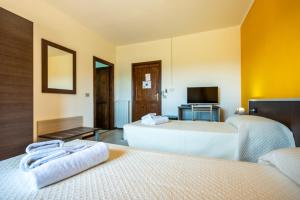 Postel nebo postele na pokoji v ubytování Hotel Marina