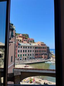 a view from a window of a beach and buildings at Nicolina 5 Il Cappero in Vernazza +6 photos