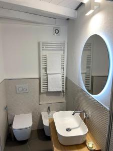 a bathroom with a sink and a toilet and a mirror at Nicolina 5 Il Cappero in Vernazza