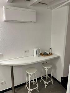 a kitchen with a counter and two stools at Nicolina 5 Il Cappero in Vernazza