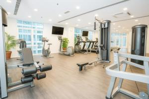 a gym with several treadmills and cardio machines at Cormar Suites Kuala Lumpur in Kuala Lumpur