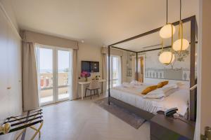 a bedroom with a large bed with a large mirror at Hotel Belvedere in Forte dei Marmi