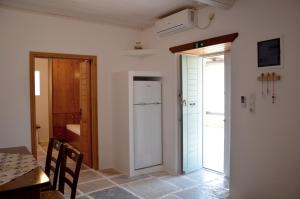 a kitchen with a table and a refrigerator and a door at Theodoti in Agia Theodoti +17 photos