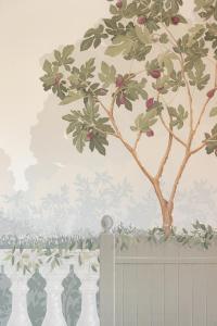 a mural of a tree on a wall with a fence at Hotel Belvedere in Forte dei Marmi
