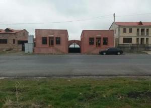 a car parked in a parking lot next to buildings at Welcome to Ashtarak in Ashtarak