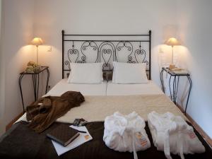 a bedroom with a large bed with two pillows at Betica Hotel Rural in Pias