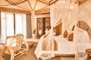 a bedroom with a bed with a mosquito net at Nuanu Suites & Accommodations in Tanah Lot +39 photos
