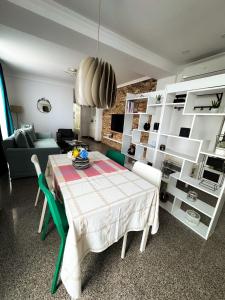 a dining room with a table and a couch at Pura Vida Mamaia Nord 2-vila exclusivista cu 3 apartamente individuale in Năvodari